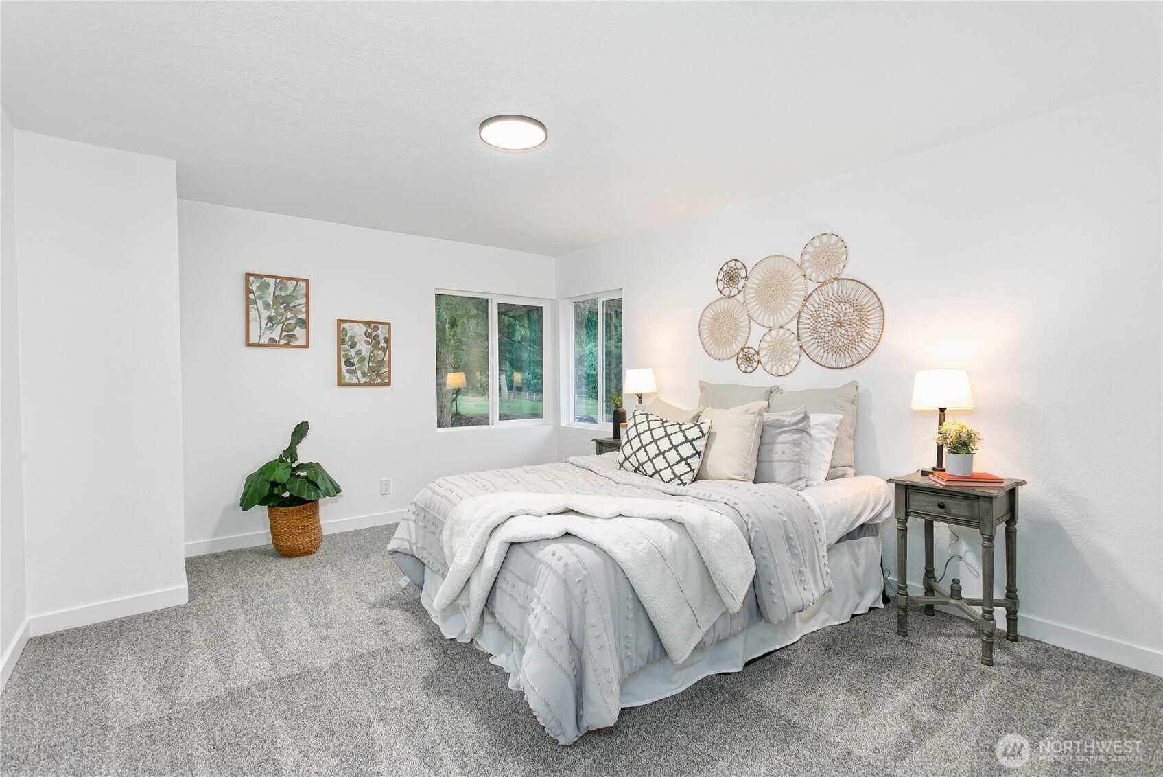 8021 Northeast Eglon Road Kingston, WA 98346 - Photo 12 of 35 a bedroom with a bed and a chandelier