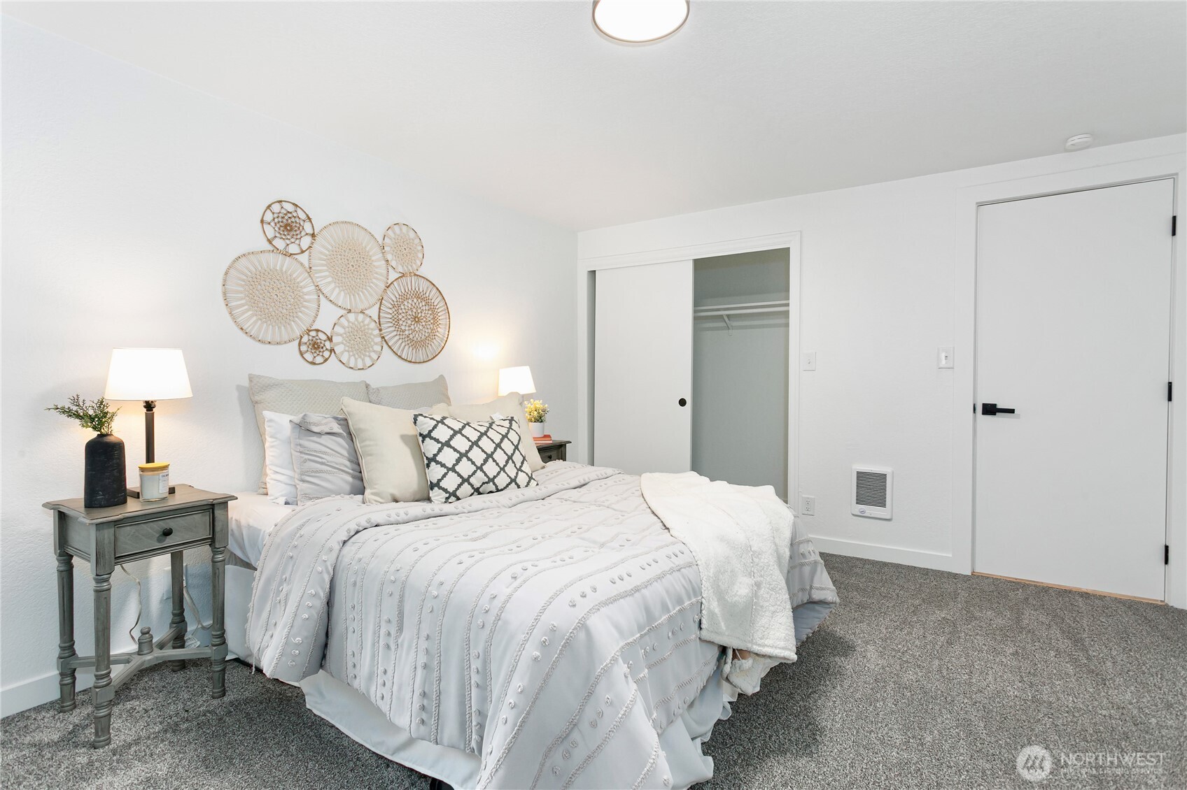 8021 Northeast Eglon Road Kingston, WA 98346 - Photo 13 of 35 a bedroom with a bed and a chandelier