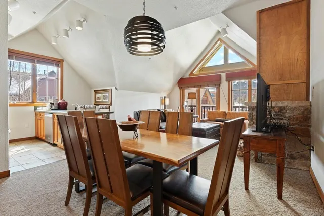 a view of a dining room with furniture wooden floor and a chandelier