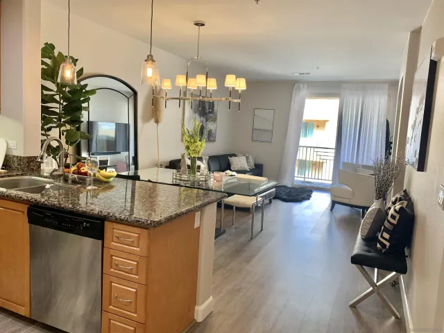 a living room with granite countertop furniture and a chandelier