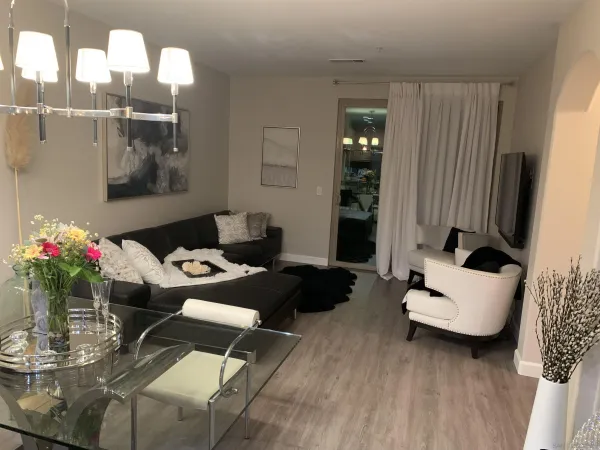 a living room with furniture and flowers