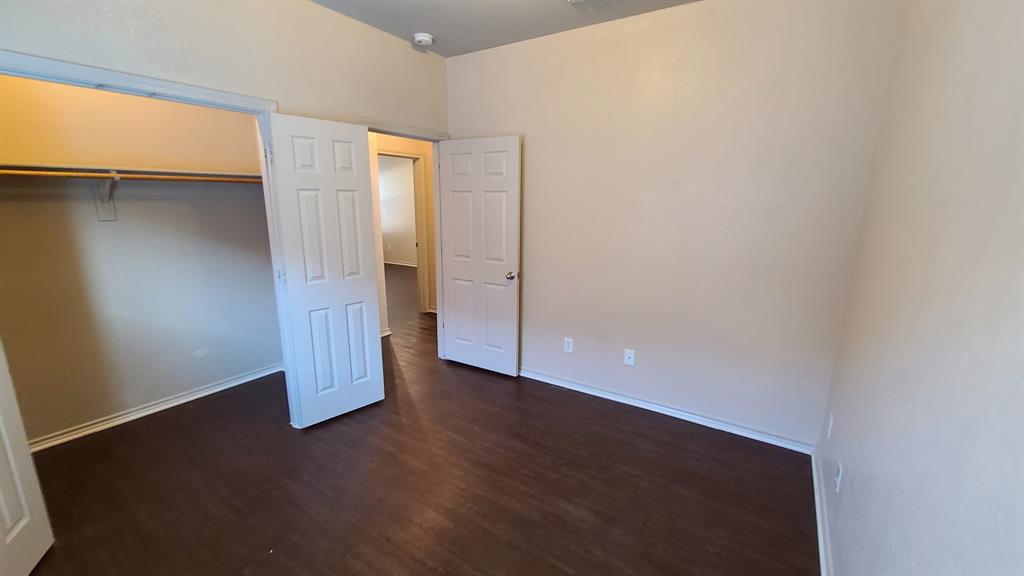 806 Walnut Street Burleson, TX 76028 - Photo 12 of 19 an empty room with wooden floor and windows