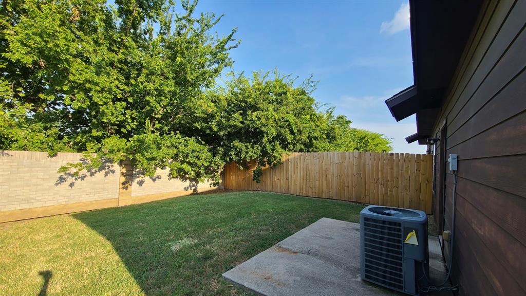 806 Walnut Street Burleson, TX 76028 - Photo 16 of 19 a view of a backyard with wooden fence