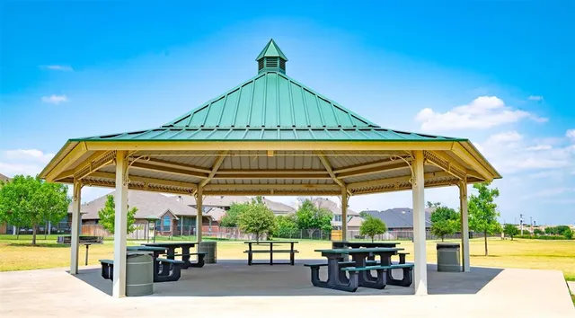 a view of patio with table and chairs under an umbrella