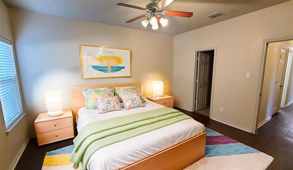 806 Walnut Street Burleson, TX 76028 - Photo 7 of 19 a bedroom with a bed and a chandelier
