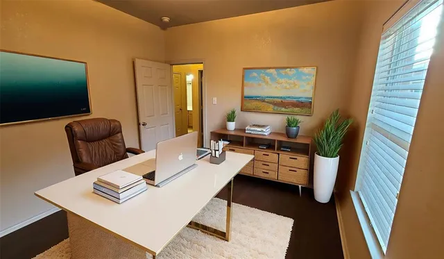 a view of a workspace with furniture and a flat screen tv
