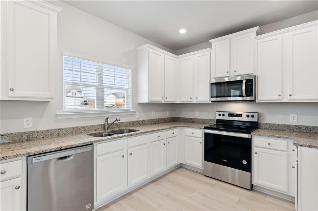 79 Water Oak Way Crawford, GA 30630 - Photo 12 of 51 a kitchen with stainless steel appliances granite countertop white cabinets granite counter tops and a window