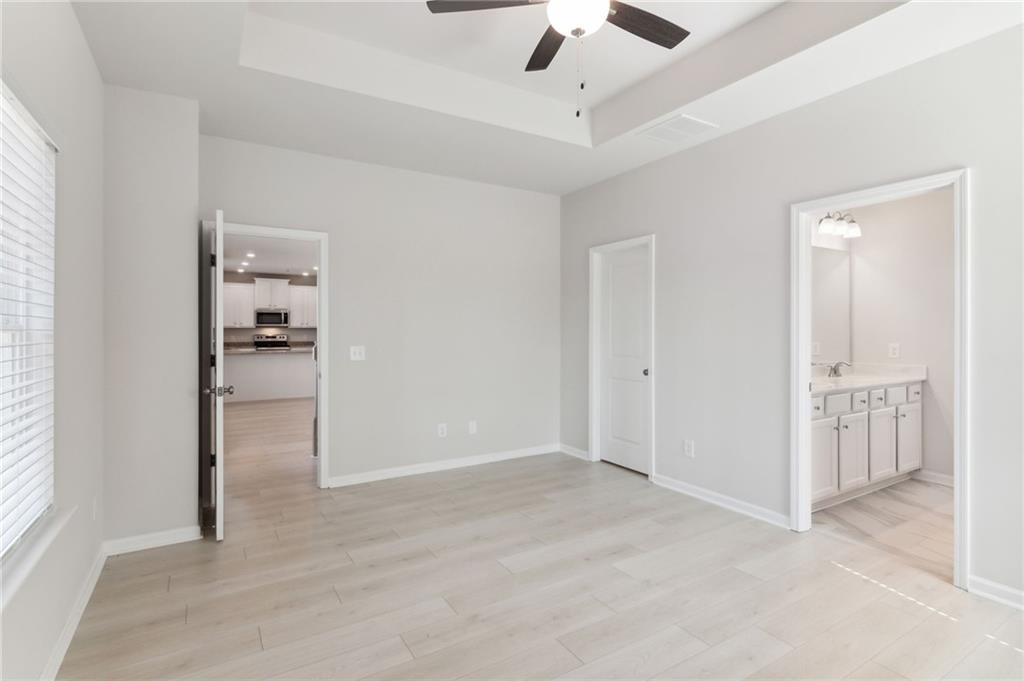 79 Water Oak Way Crawford, GA 30630 - Photo 15 of 51 an empty room with chandelier fan and windows