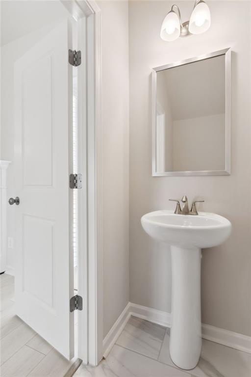 79 Water Oak Way Crawford, GA 30630 - Photo 20 of 51 a bathroom with a sink a mirror and shower