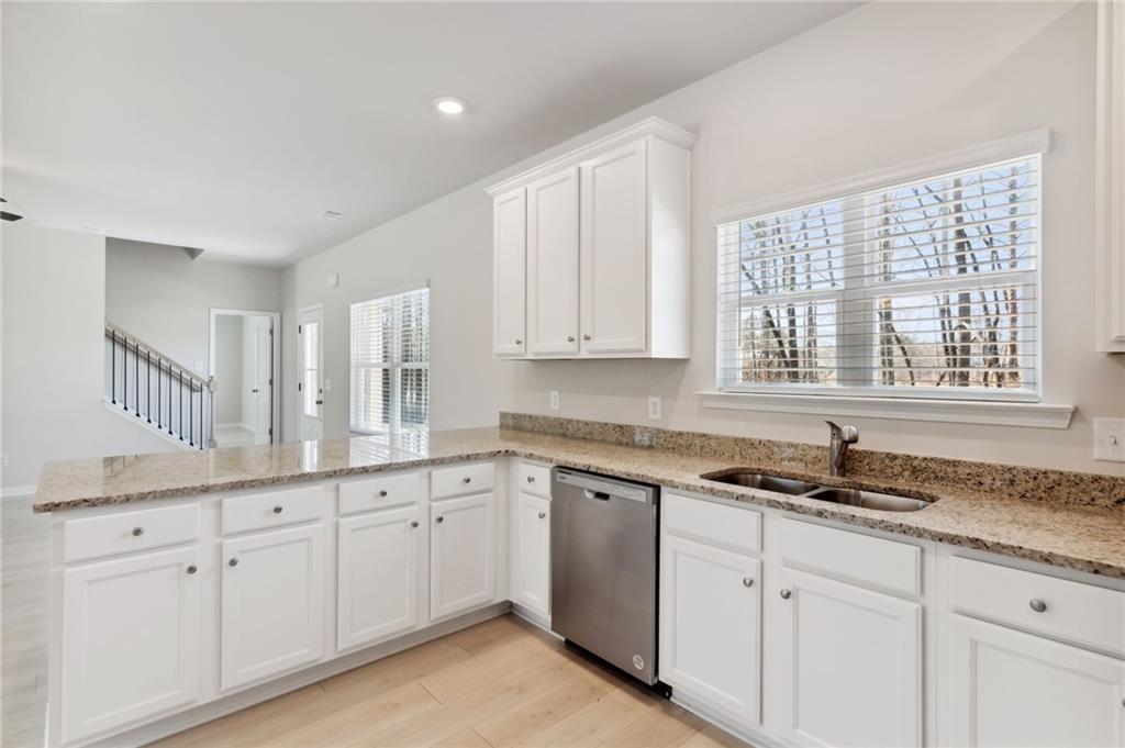 79 Water Oak Way Crawford, GA 30630 - Photo 22 of 51 a kitchen with white cabinets and a sink