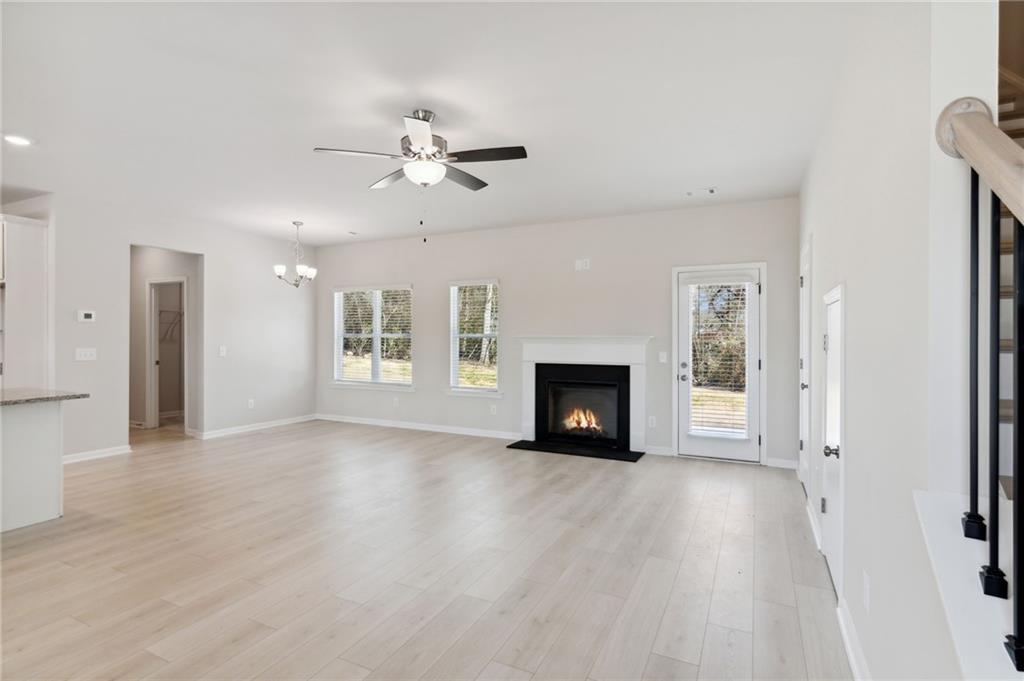 79 Water Oak Way Crawford, GA 30630 - Photo 6 of 51 a view of an empty room with a fireplace and a window