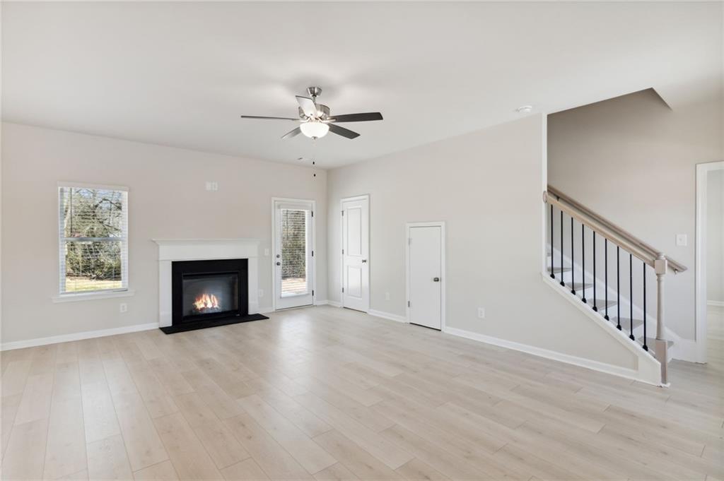 79 Water Oak Way Crawford, GA 30630 - Photo 7 of 51 a view of an empty room with a fireplace and a window