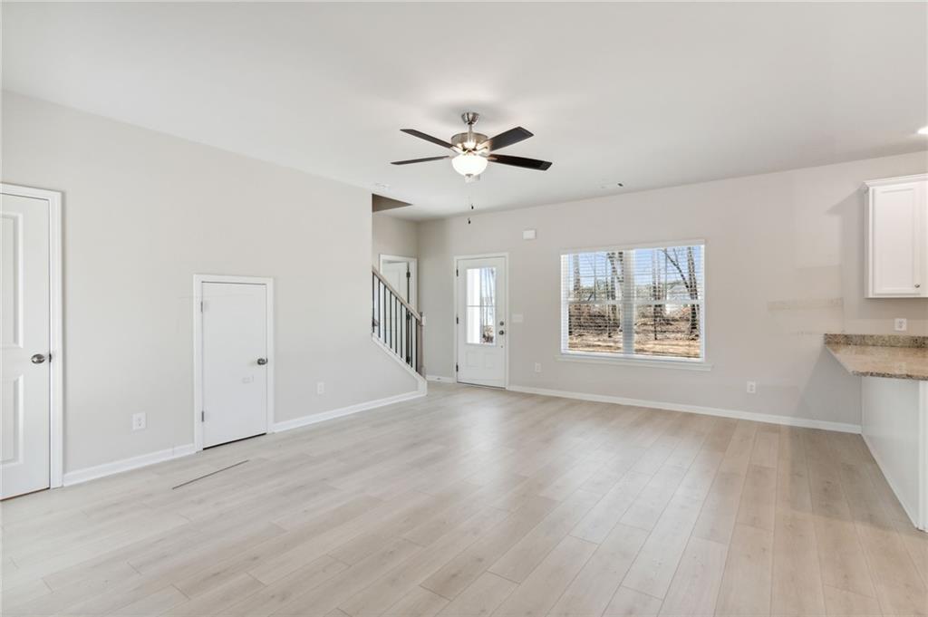 79 Water Oak Way Crawford, GA 30630 - Photo 8 of 51 a view of an empty room with a window and wooden floor