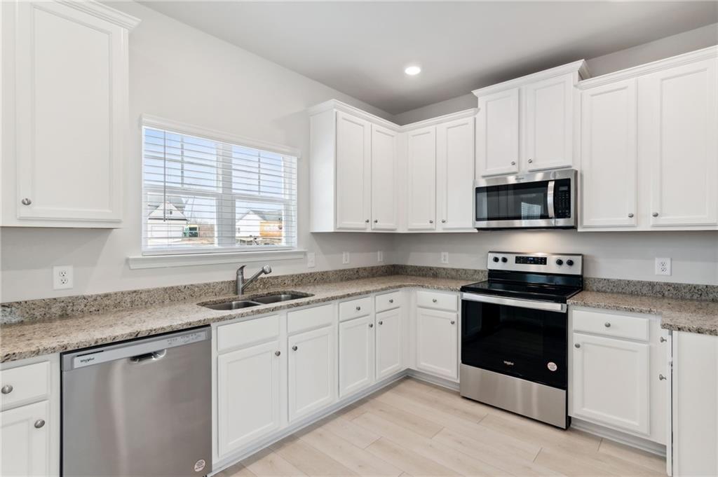 79 Water Oak Way Crawford, GA 30630 - Photo 10 of 51 a kitchen with stainless steel appliances granite countertop white cabinets granite counter tops and a window