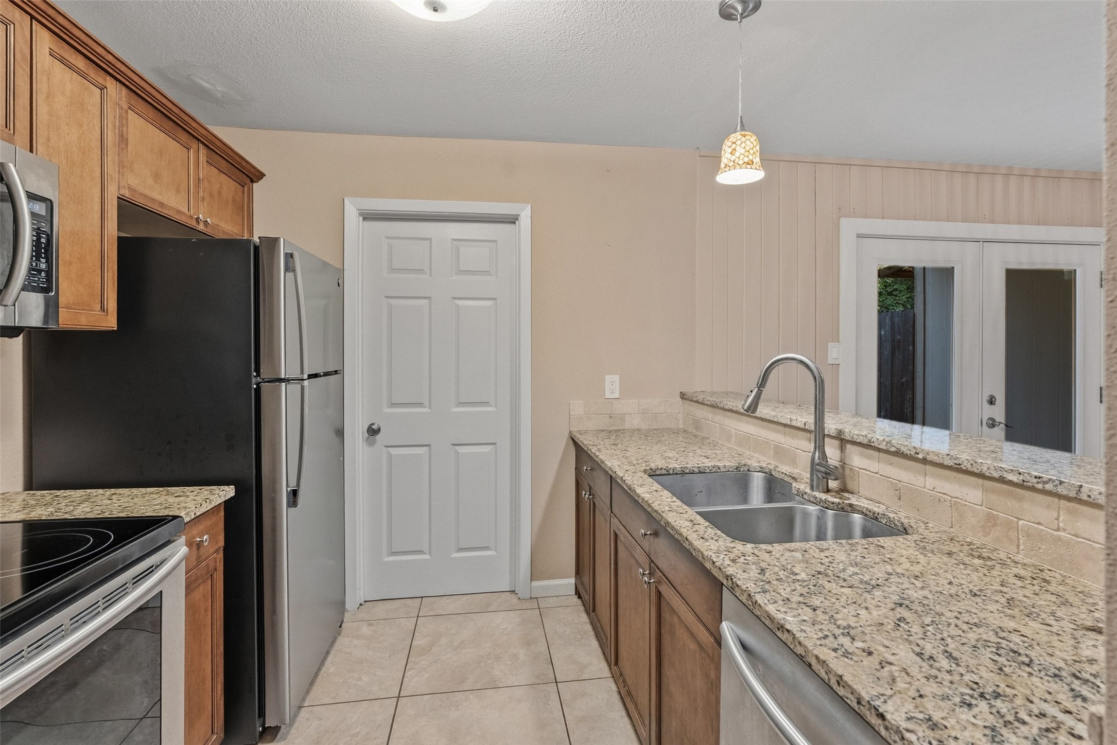 702 Castle Ridge Road, Unit C Austin, TX 78746 - Photo 35 of 36 This updated two-story residence offers approximately 1,144 square feet with 2 bedrooms, 1.5 bathrooms, and an open floor plan filled with natural light. Features include vinyl and tile flooring throughout with no carpet, granite countertops, and a walk-in shower. The main level features a comfortable living area that flows into the dining space and kitchen, creating an ideal setting for daily living and entertaining.