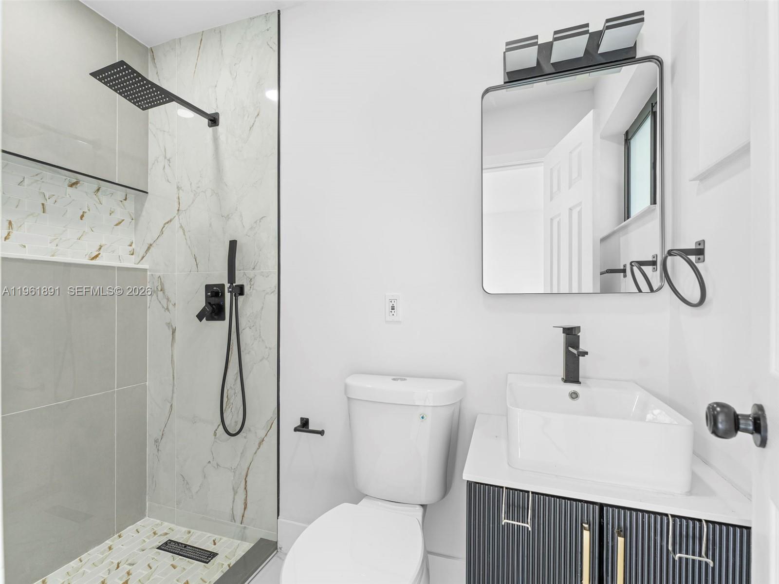 2500 Southwest 23rd Terrace Miami, FL 33145 - Photo 24 of 36 a bathroom with a toilet sink shower and mirror