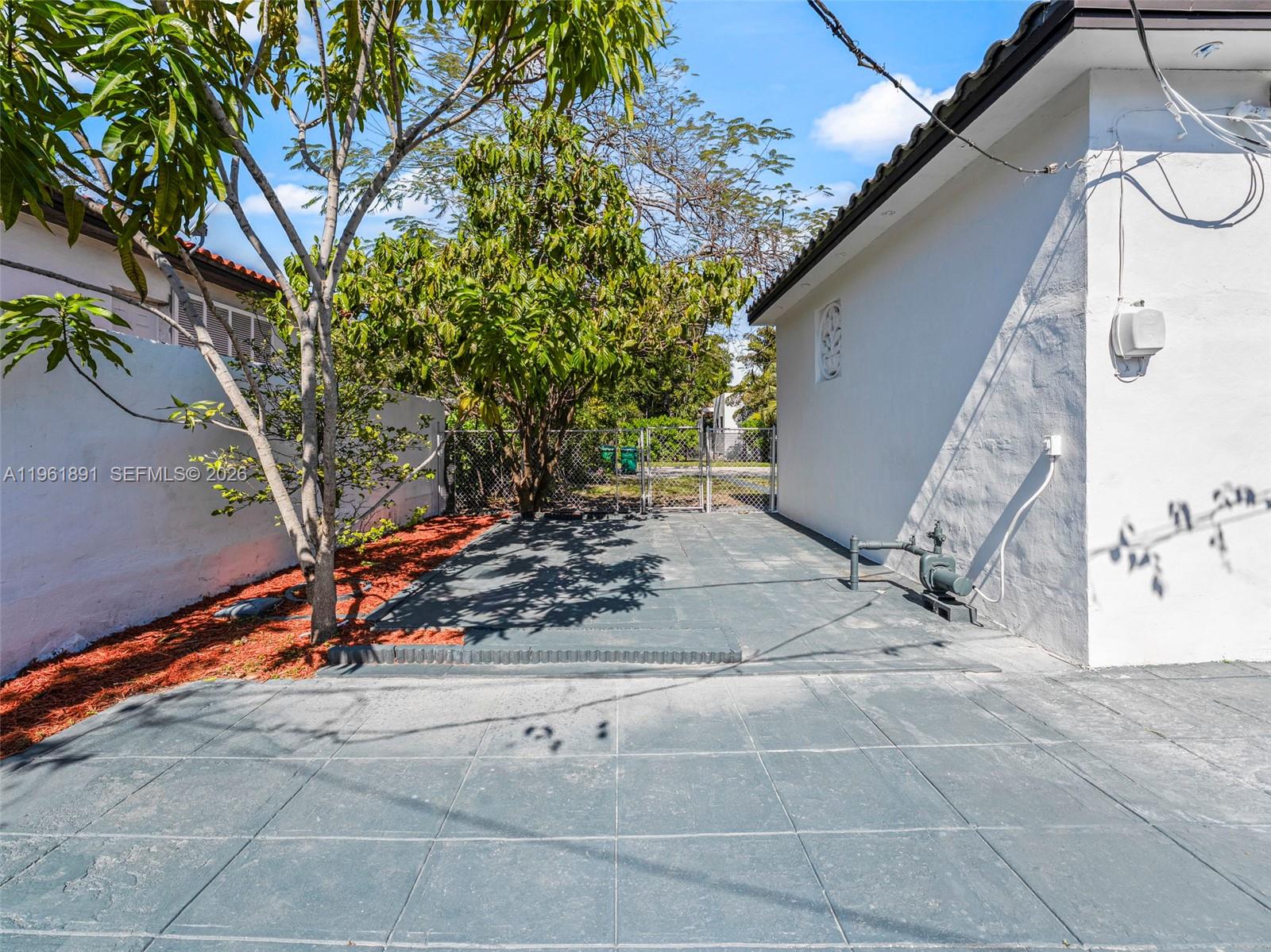 2500 Southwest 23rd Terrace Miami, FL 33145 - Photo 26 of 36 a view of a backyard with floor to ceiling window and a tree
