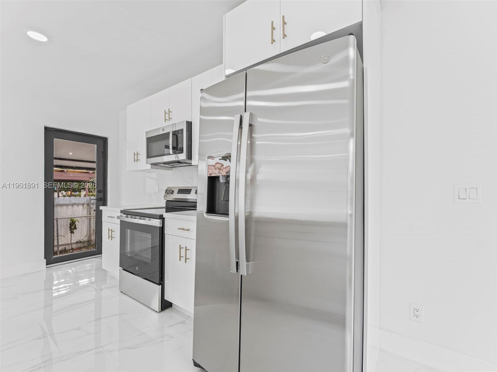 2500 Southwest 23rd Terrace Miami, FL 33145 - Photo 9 of 36 a kitchen with a refrigerator and a stove top oven