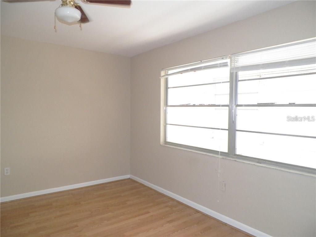 911 Washington Avenue Southwest, Unit 304 Largo, FL 33770 - Photo 14 of 26 a view of an empty room with wooden floor and a window
