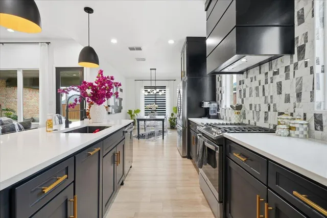 a kitchen with sink stove and cabinets