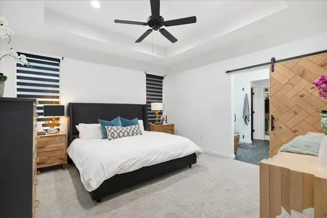 a bedroom with a bed and a chandelier