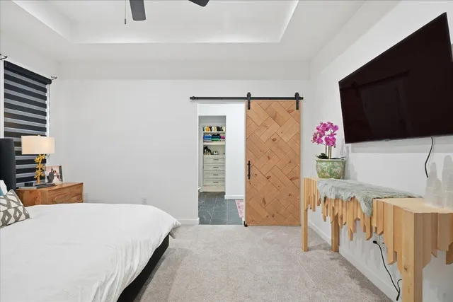 a bedroom with a bed and a flat screen tv