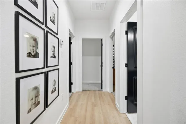a view of a hallway with wooden floor and staircase
