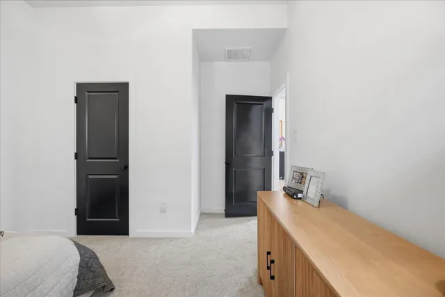 a room with a bed and a mirror