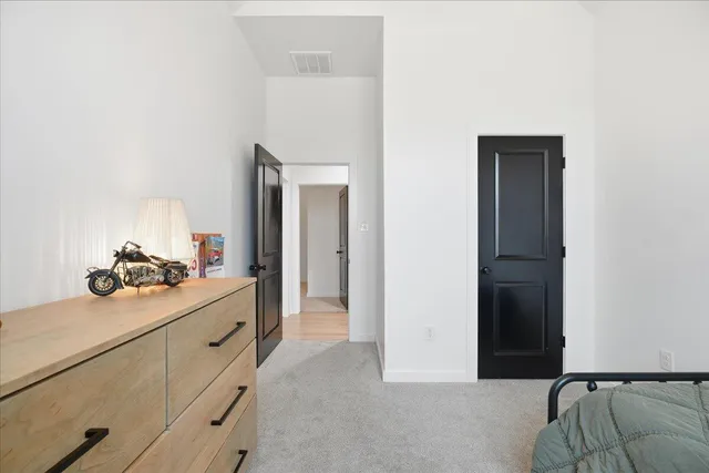 a bedroom with a bed and a dresser