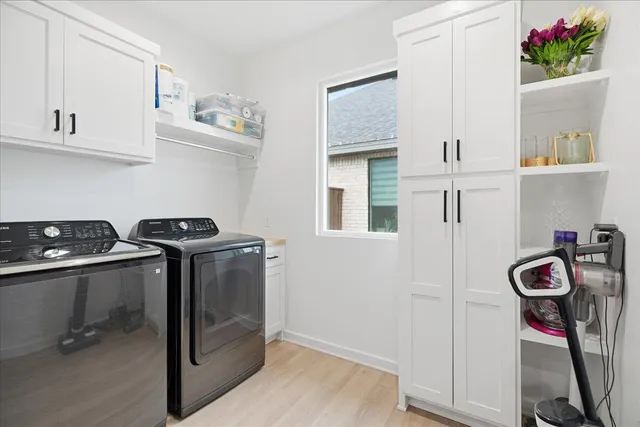 a utility room with sink dryer and washer