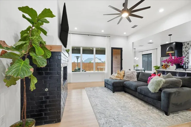 a living room with furniture flowerpot and a chandelier