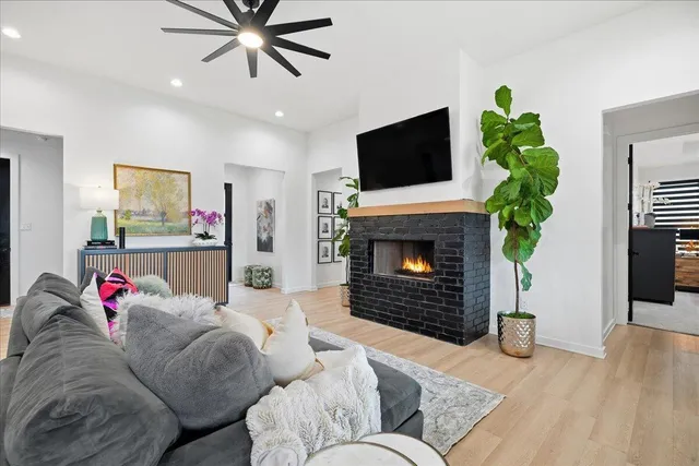 a living room with furniture fireplace and flat screen tv