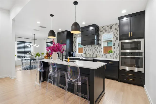 a kitchen with stainless steel appliances granite countertop a stove and a sink