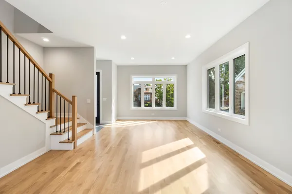 a view of an entryway with wooden floor and windows