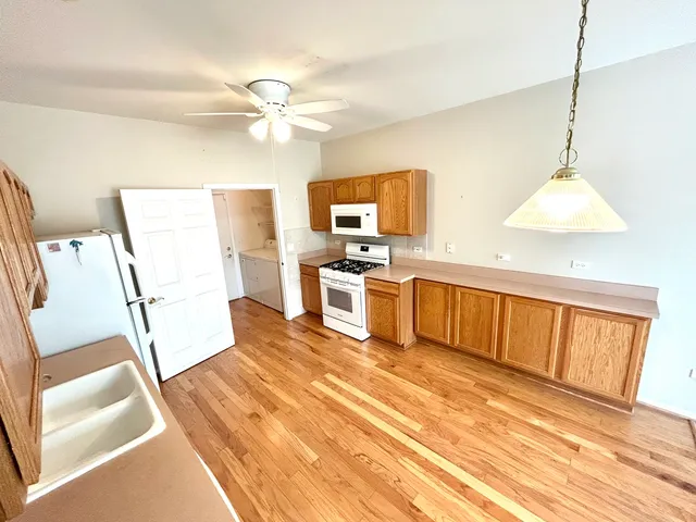 a kitchen with stainless steel appliances a stove a sink and a refrigerator