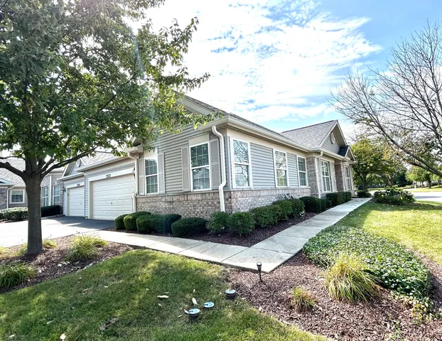 a front view of a house with a yard and outdoor seating