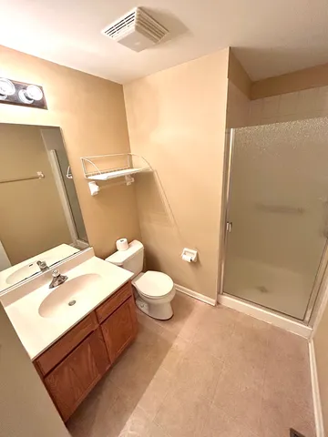 a bathroom with a sink mirror and toilet
