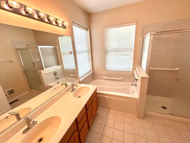 a bathroom with a tub sink and a mirror