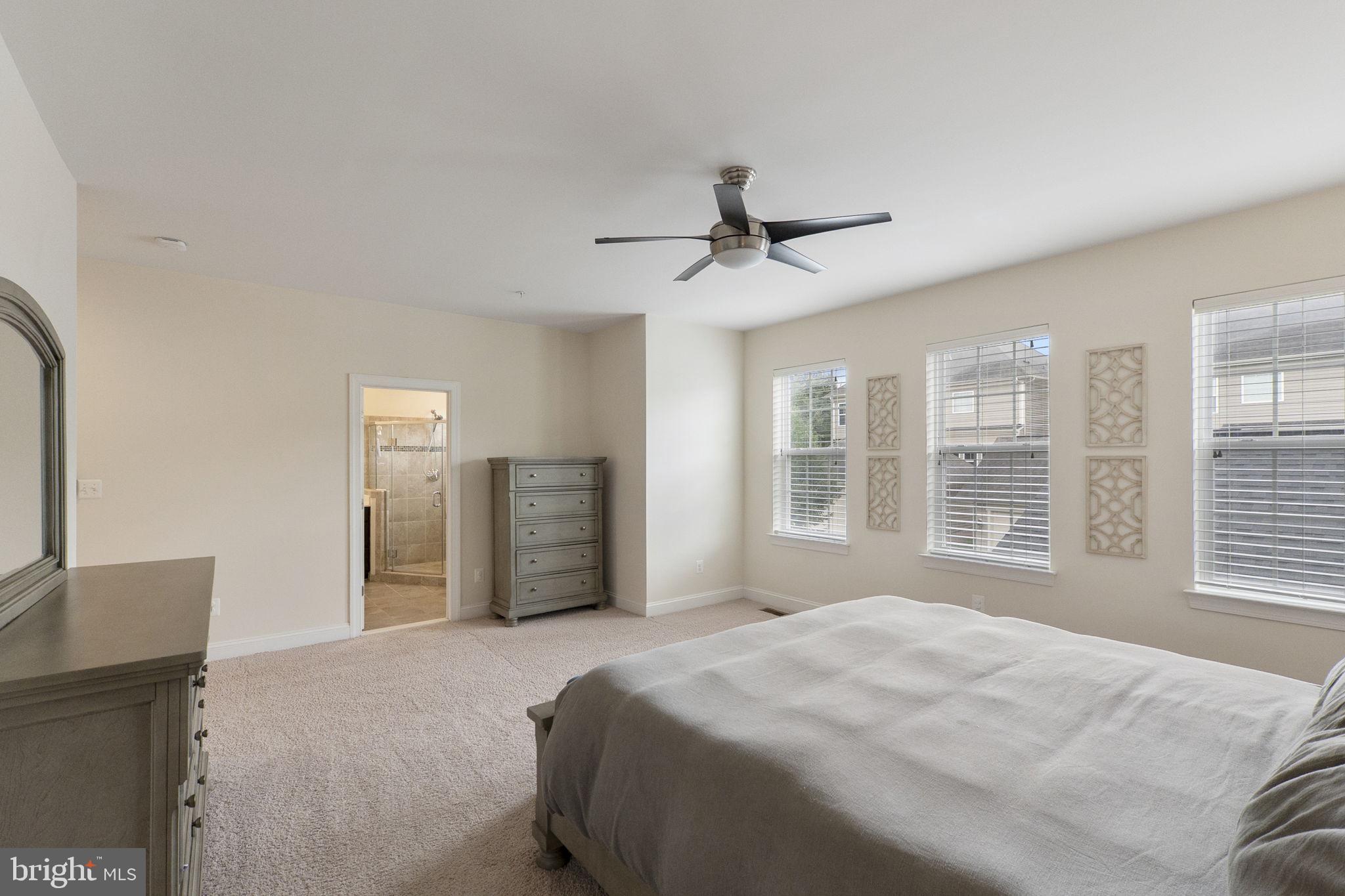 23902 Grapevine Ridge Terrace Clarksburg, MD 20871 - Photo 17 of 44 a spacious bedroom with a large bed and a large window