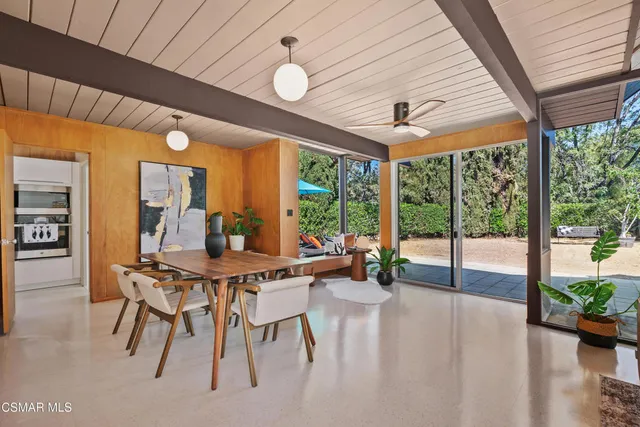 a view of a dining room with furniture and a large window