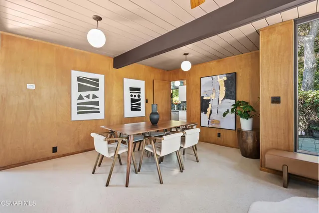 a spacious bedroom with a bed and glass walk in closet