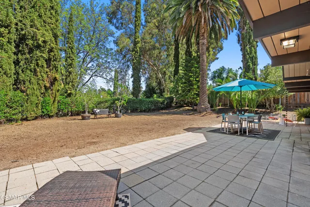 a front view of a house with a garden and plants