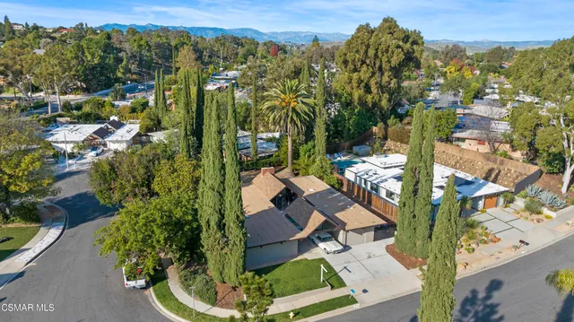 an aerial view of multiple houses with yard