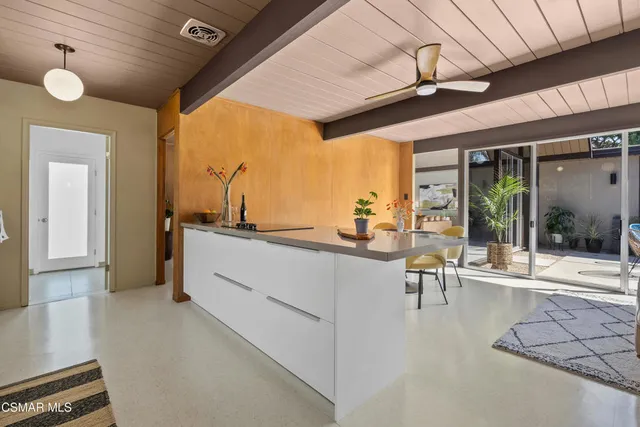 a kitchen with sink and refrigerator