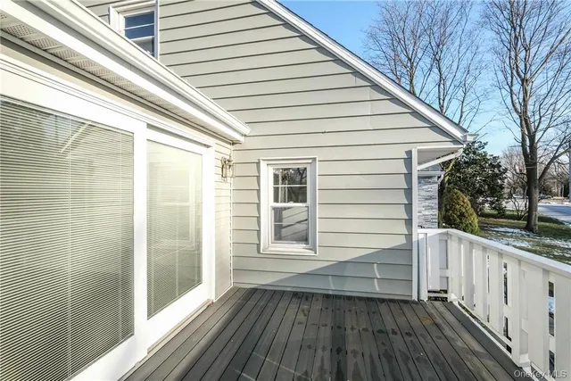 a view of a balcony with wooden floor and fence