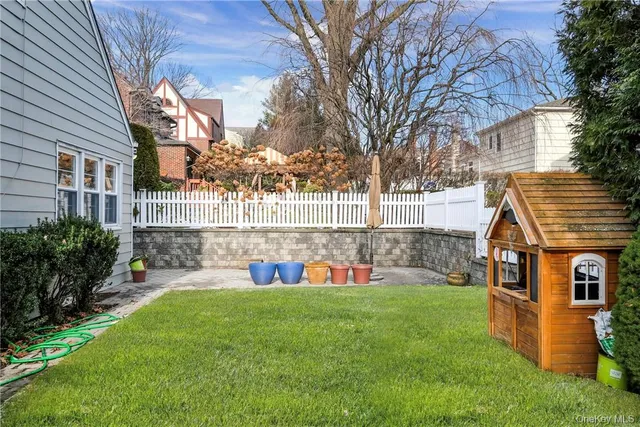 a view of a house with a yard and sitting area
