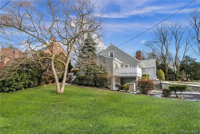 a front view of a house with a garden and yard