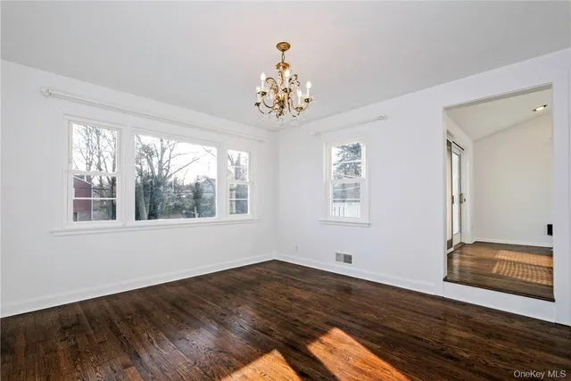 a view of wooden floor and windows in a room