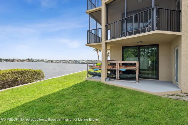 a view of a house with a yard deck and sitting area