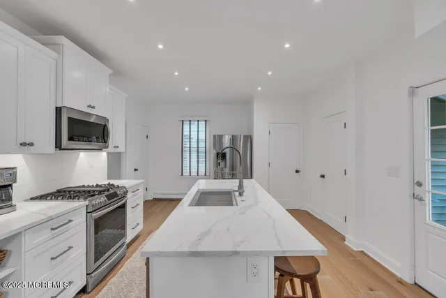 a kitchen with granite countertop a stove and a sink